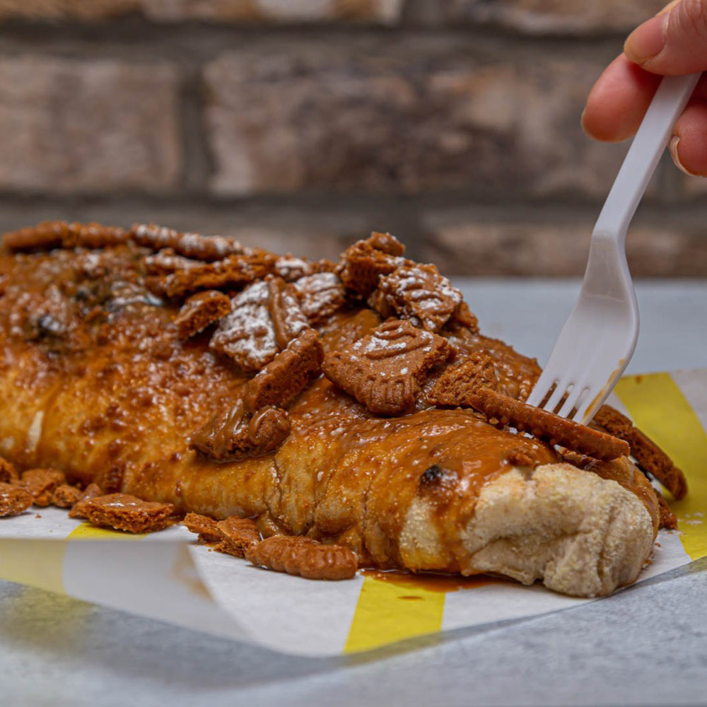 Sweet baked pastry topped with caramel sauce and biscuits served at Bene’s