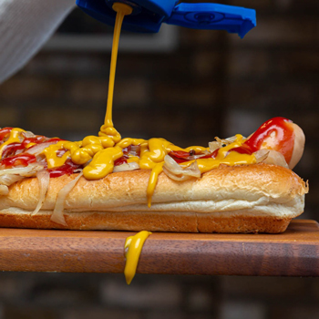 Bene’s in Preston Pans hot dog in a toasted bun and a thick stream of bright yellow mustard.